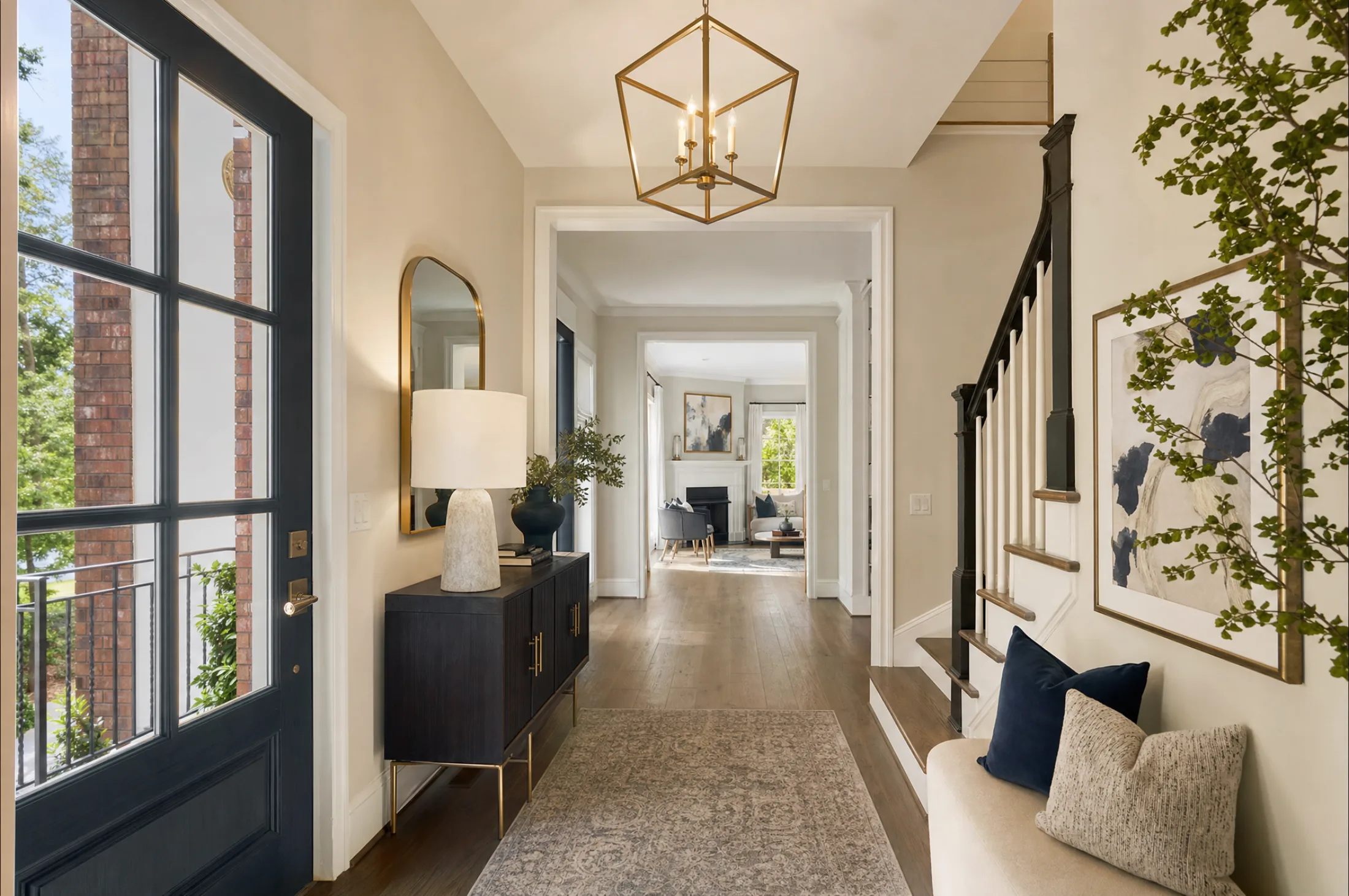 Staged great room in an Alpharetta new construction model home with a neutral palette and oversized lantern fixture