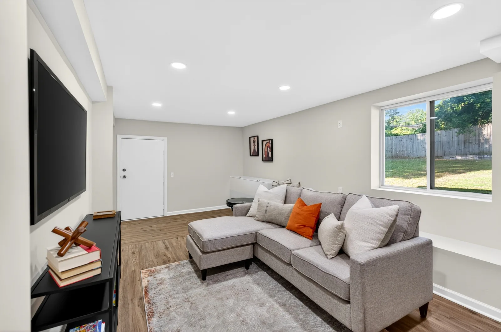 Staged den with warm accent pillow