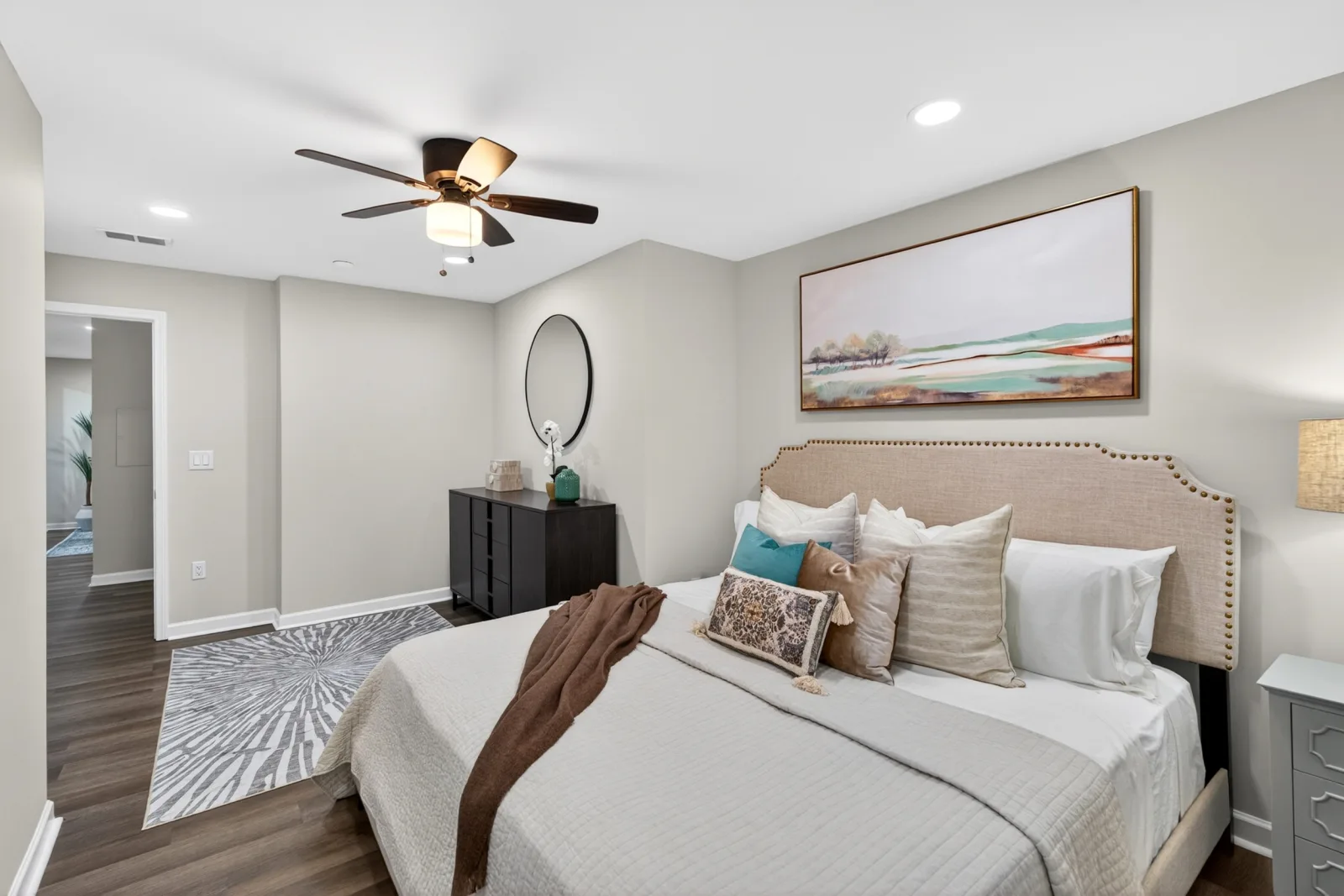 Staged guest bedroom with teal accents